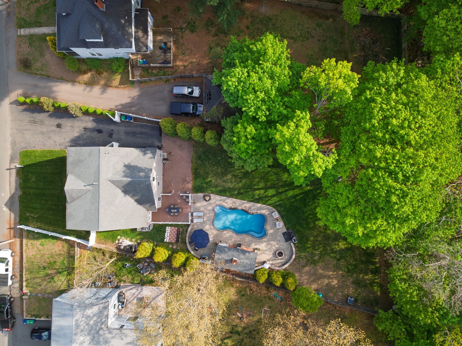 Aerial view of the backyard showing the heated saltwater pool, pavilion, and paver patio