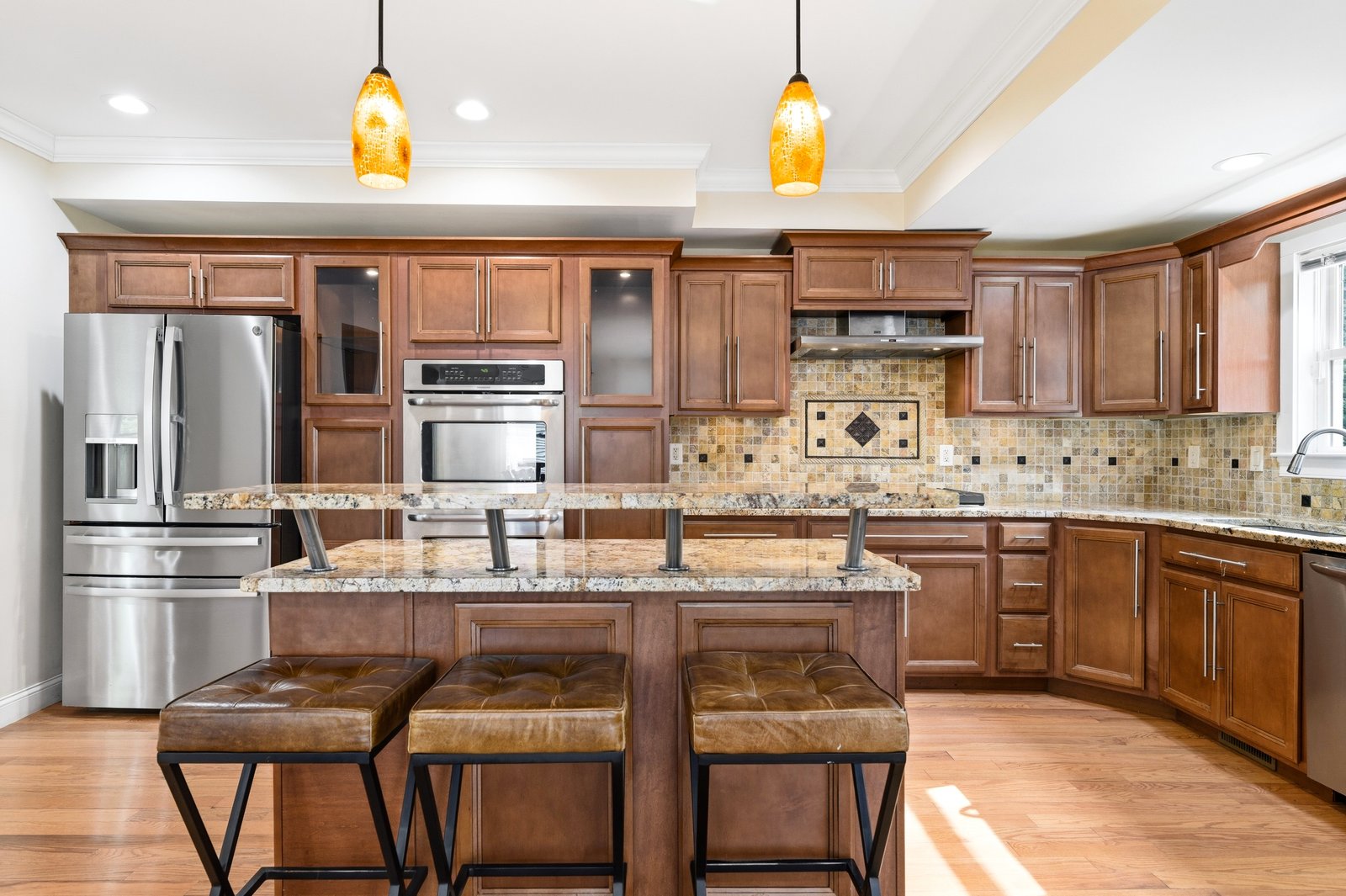 Gourmet kitchen with vaulted ceiling, granite countertops, center island, and stainless steel double wall oven
