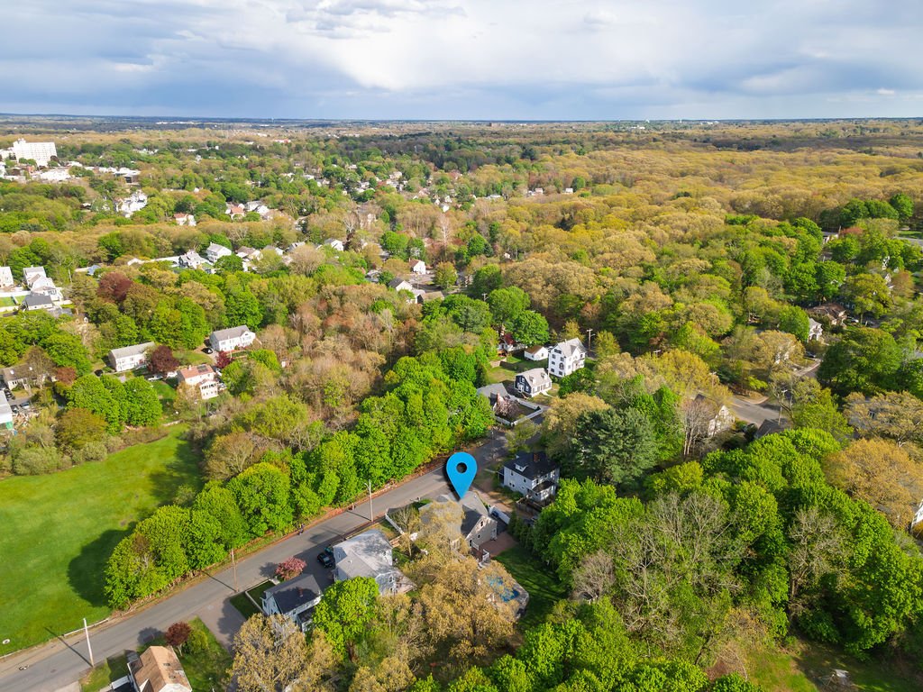 Aerial view of 51 Faxon Street and the surrounding East Braintree neighborhood with Davis Park visible across the street